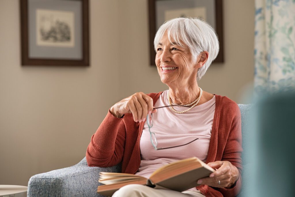 Woman smiling while holding a book