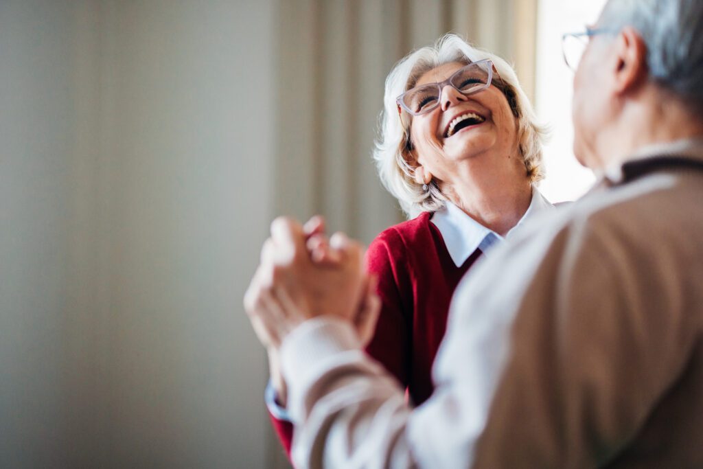Senior couple smiling and dancing